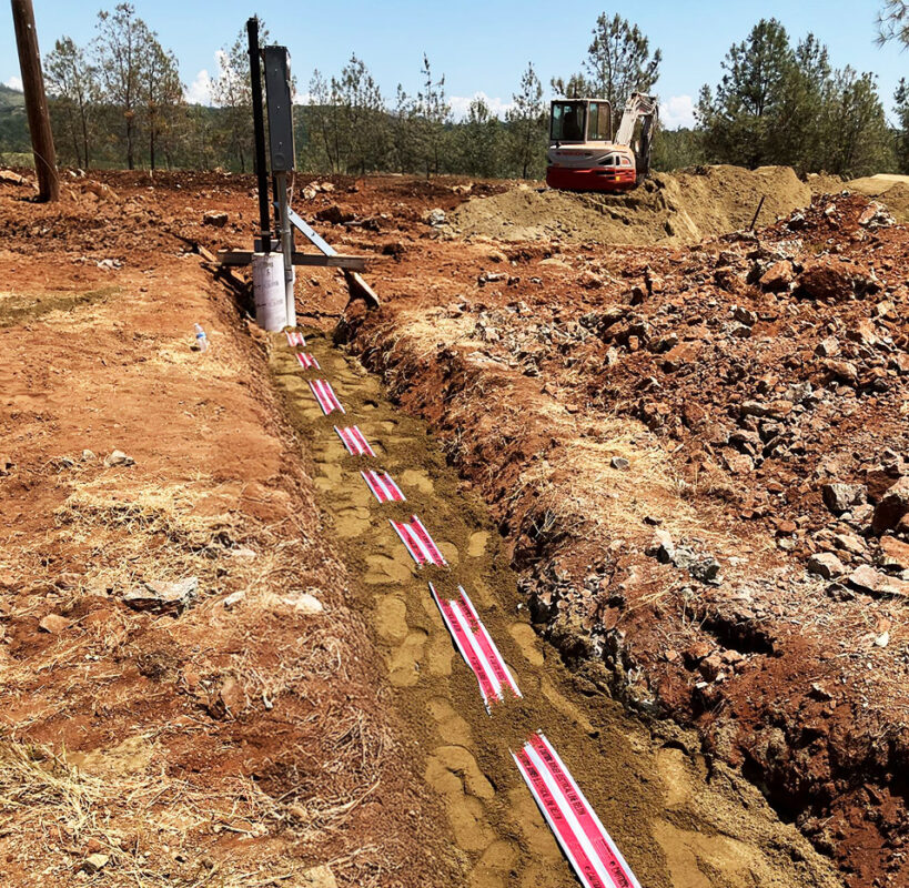 Underground electrical conduit installation project with red warning tape by VEK Construction in Northern California