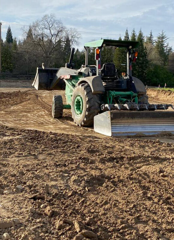 Precision land grading and site preparation by VEK Construction in Sacramento, CA — heavy machinery creating a smooth, level foundation.