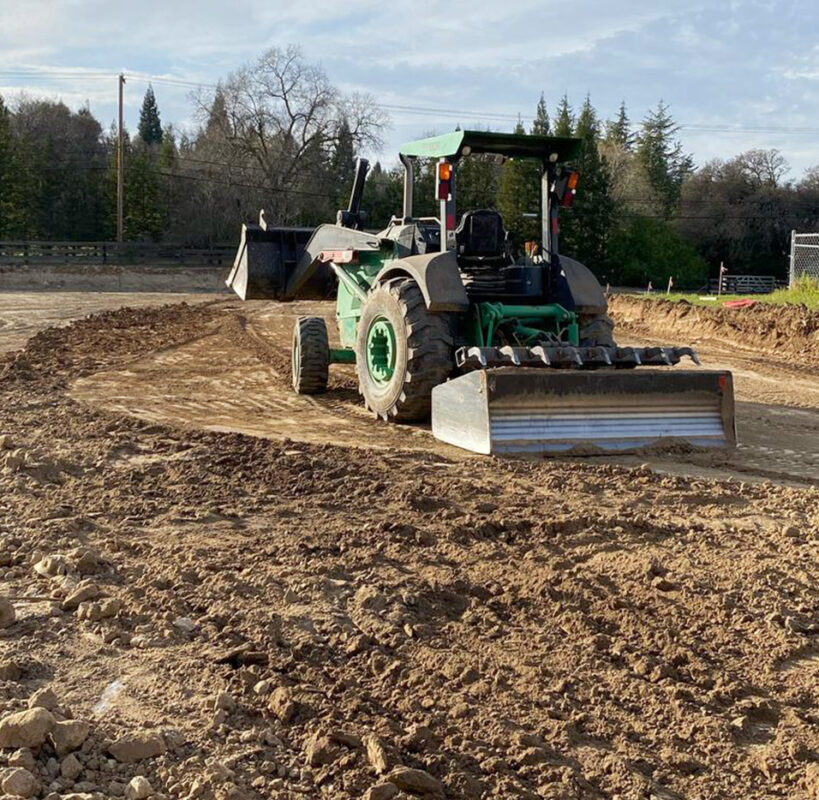Precision land grading and site preparation by VEK Construction in Sacramento, CA — heavy machinery creating a smooth, level foundation.