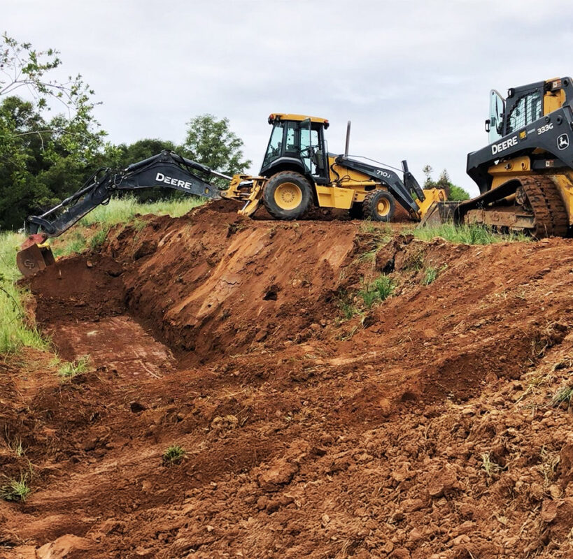 John Deere excavators and dozer performing site grading and slope excavation for residential development — VEK Construction Sacramento.
