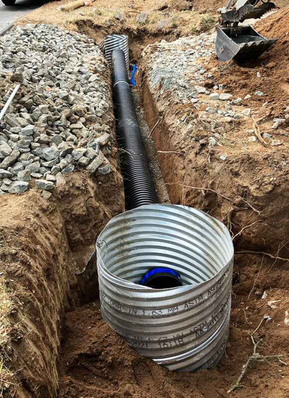 Culvert drainage system installation with HDPE pipe and metal inlet by VEK Construction — expert stormwater management Sacramento County.