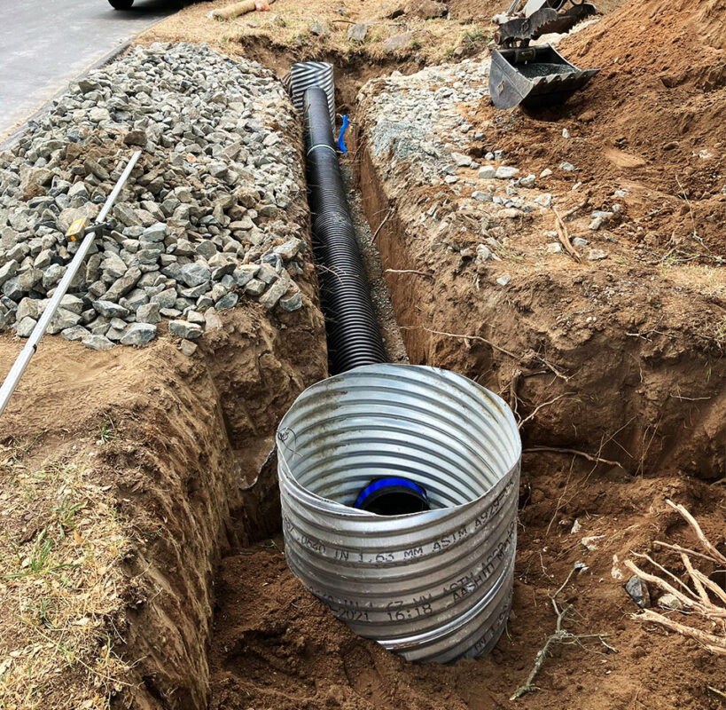 Culvert drainage system installation with HDPE pipe and metal inlet by VEK Construction — expert stormwater management Sacramento County.